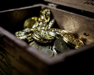 A vibrant graphic showing a treasure chest overflowing with coins and gems.
